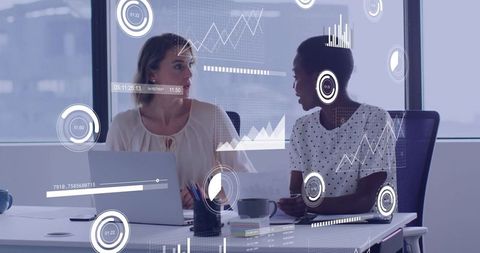 Businesswomen Collaborating with Augmented Data Visualizations in Modern Office Meeting