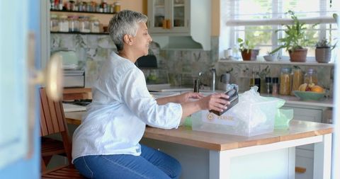 Senior Woman Recycling at Home Kitchen
