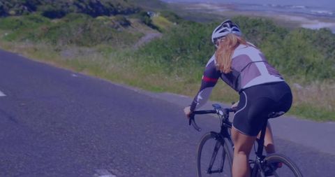 Cyclist riding road bike on scenic countryside