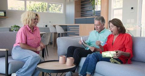 Family Celebrating Surprise Gift with Excitement at Home