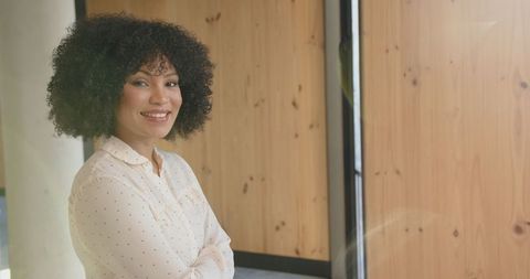 Confident Professional Woman Standing in Modern Office Environment