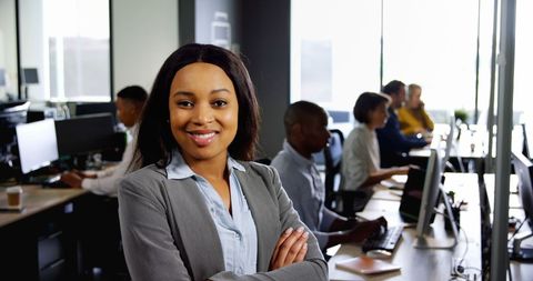 Confident Female Professional Smiling in Modern Office Setting