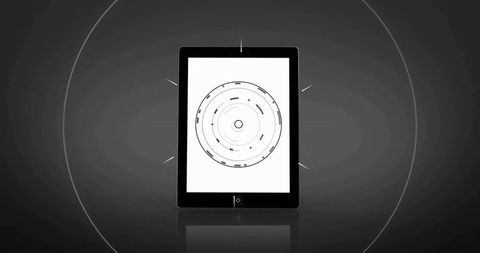 Tablet powering up with concentric HUD rings on minimalist grayscale display, reflective surface