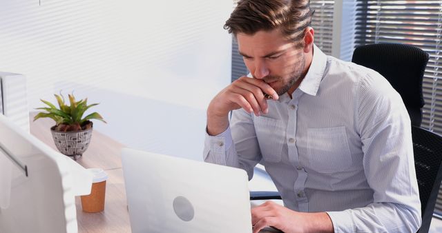 Focused Professional Man Working at Desk with Laptop in Office - Download Free Stock Images Pikwizard.com