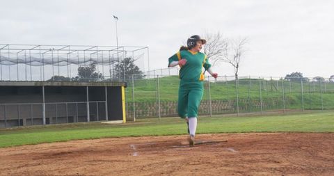 Teen softball player performing rapid pitch