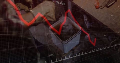 Industrial technician analyzing red line drop on graph