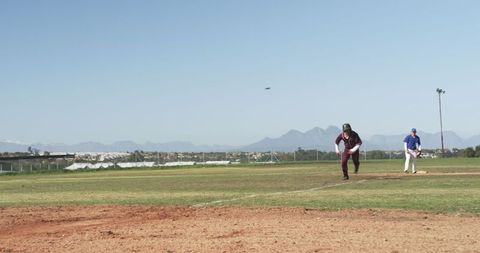 Athletic Baseball Player Sprinting Towards Base on a Clear Day