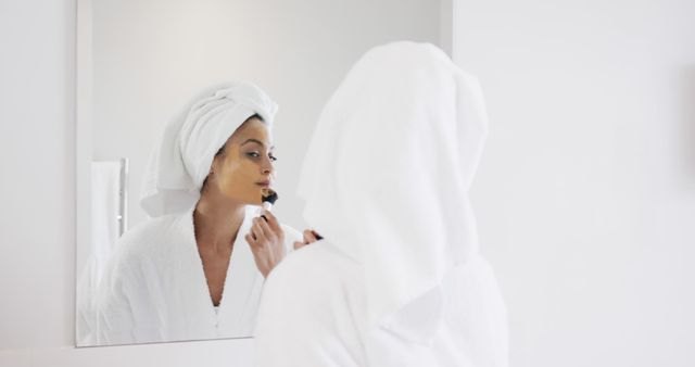 Young Woman Applying Makeup While Looking in Mirror with Towel on Head - Download Free Stock Images Pikwizard.com