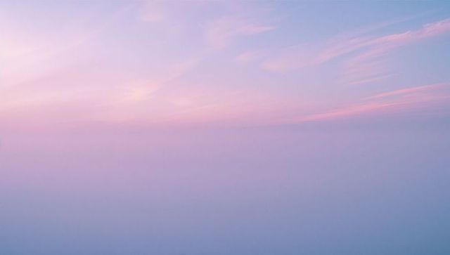 Serene Morning Sky with Pastel Gradient and Wispy Clouds