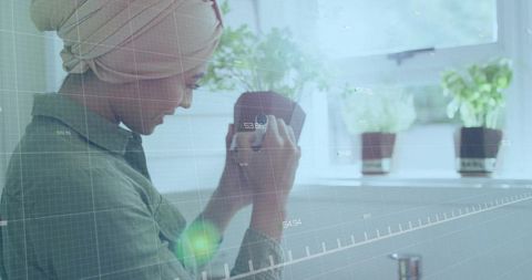 Woman with turban enjoying indoor succulent gardening at home