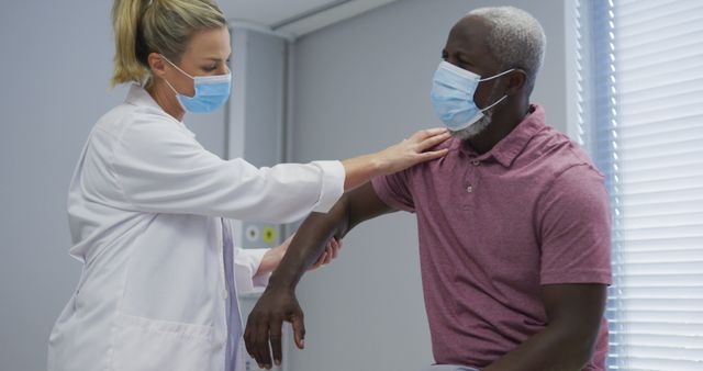 Doctor Examining Senior Patient with Face Masks in Medical Clinic - Download Free Stock Images Pikwizard.com