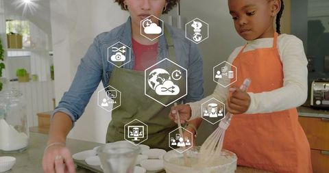 Mother and daughter baking together in sunlit kitchen with digital overlay icons