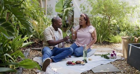 Couple Relaxing at Romantic Garden Picnic on Sunny Day