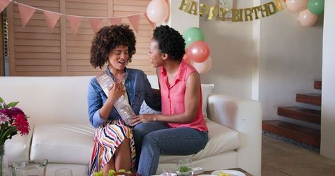 Joyful Home Birthday Celebration with Diverse Female Couple