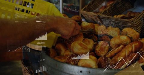 Hand reaching for seeded roll with tongs at market bakery stall with analytics chart overlay