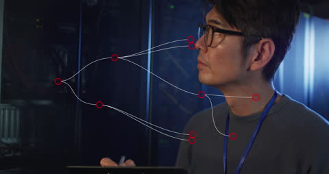Asian IT Engineer Analyzing Complex Network Connections