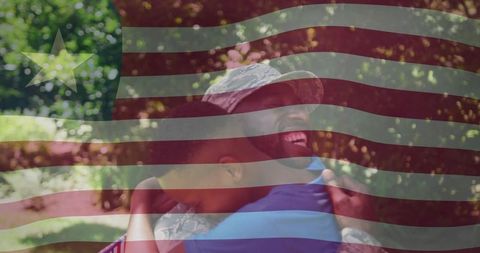 West African Soldier and Son Reuniting Outdoors with Flag Overlay