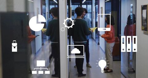 Team collaborating in glass office corridor with technology icons overlay