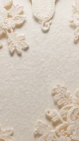 Sliding Camera Revealing Cream Embossed Floral Plaster Panel in Vertical Video