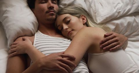 Couple Relaxing Together in Bed Embracing Calmness