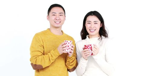 Happy Couple Enjoying Hot Drinks in Cozy Attire