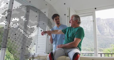 Senior man receiving assisted arm rehabilitation from therapist with digital dotted overlay