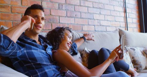 Young Couple Relaxing at Home with Phone and Tablet - Download Free Stock Images Pikwizard.com