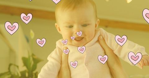 Adorable baby with overlay of animated hearts