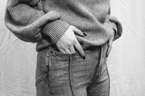 Close-up of casual fashion featuring sweater and jeans