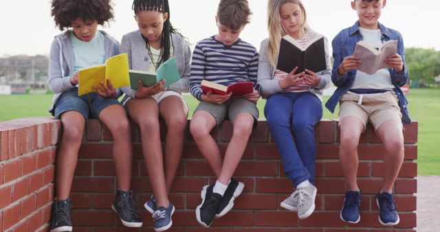 Diverse Children Reading Books Together Outdoors on Brick Wall - Download Free Stock Images Pikwizard.com