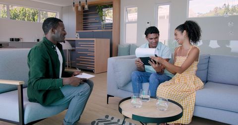 Couple consulting with advisor in bright modern living room