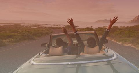 Joyful Couple Enjoying Scenic Drive in Cabriolet at Sunset - Download Free Stock Images Pikwizard.com