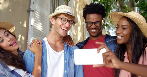 Diverse Friends Smiling and Taking Selfie Outdoors on Sunny Day