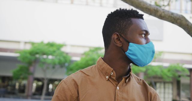 Man Wearing Face Mask Standing Outdoors in City Environment - Download Free Stock Images Pikwizard.com