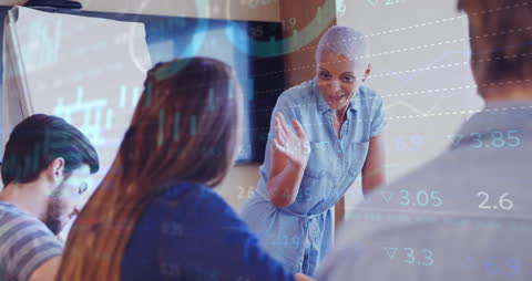 Diverse Team Analyzing Financial Trends in Modern Meeting