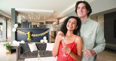 Happy Couple Celebrating Anniversary with Champagne at Home
