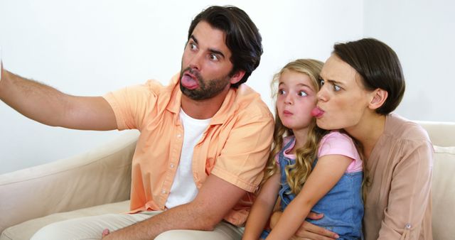 Family Making Funny Faces While Taking Selfie on Sofa - Download Free Stock Images Pikwizard.com