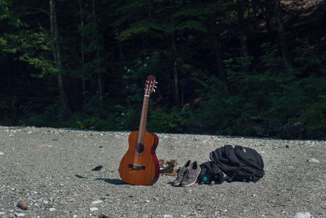 Acoustic Guitar and Backpack Set on Forest Trail - Download Free Stock Photos Pikwizard.com