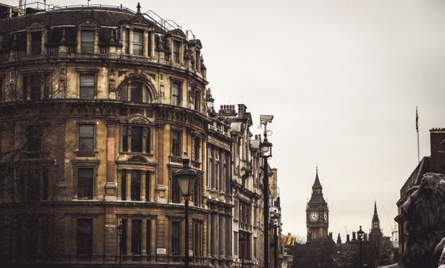 This image showcases the old-world charm of London with a view of the iconic Big Ben clock tower amidst historical buildings. Ideal for use in travel blogs, tourism advertisements, cityscapes artwork, historical content, and guides about London. Perfect for highlighting the architectural beauty and cultural landmarks of the UK.