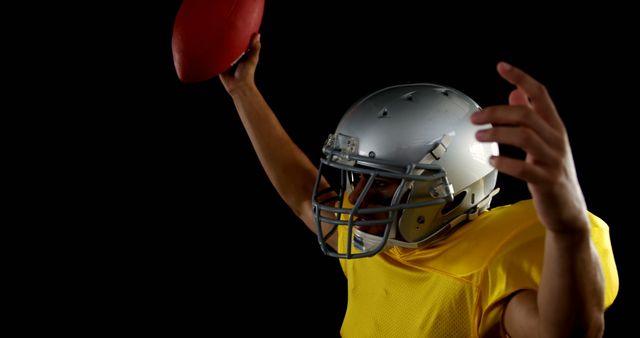 Football player wearing helmet and yellow jersey preparing to throw ball. Perfect for sports themes, athletic promotions, team branding, and game-related content.