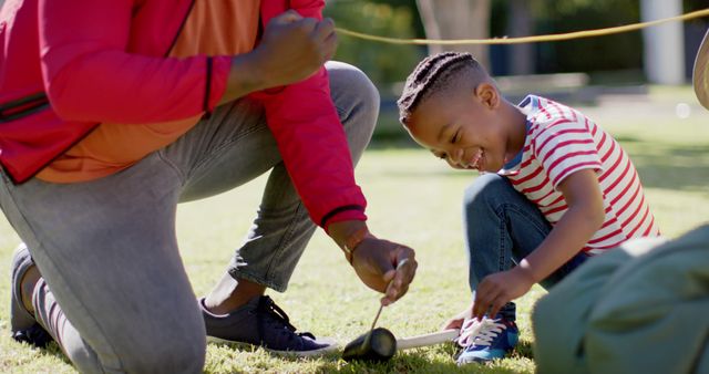 Father and son engaged in fun outdoor play activity - Download Free Stock Images Pikwizard.com