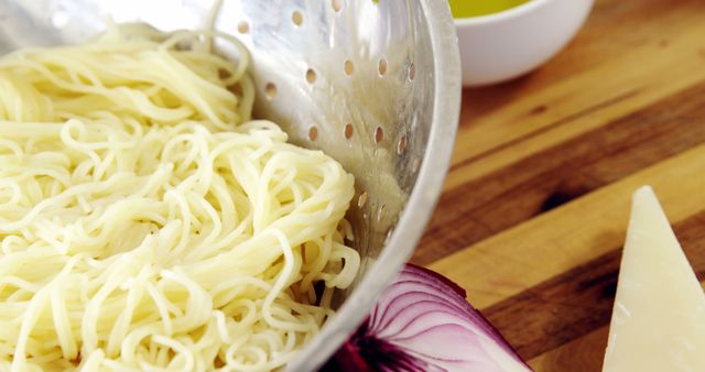 Freshly Cooked Pasta Draining in Colander with Onion and Cheese - Download Free Stock Images Pikwizard.com