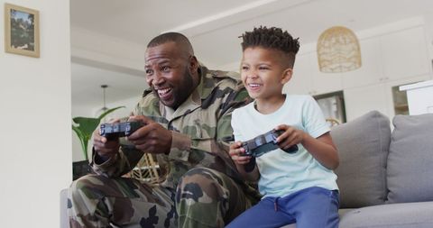 Father and Son Bonding Playing Video Games at Home