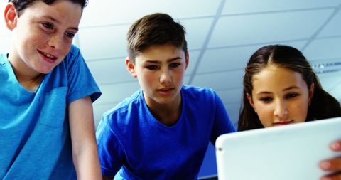 Young Students Using Tablet in Classroom Setting