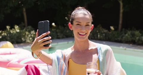 Elegant Woman Enjoying Leisure by Backyard Pool