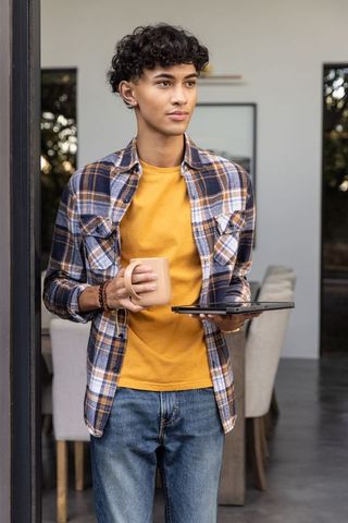 Young man relaxing with tablet in modern dining area