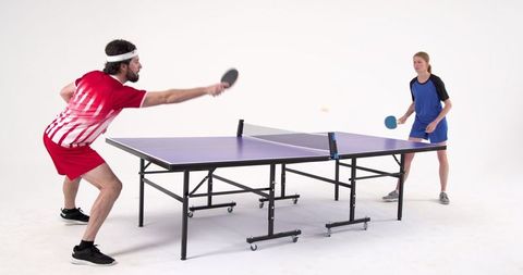 Energetic Friends Enjoying Intense Table Tennis Match