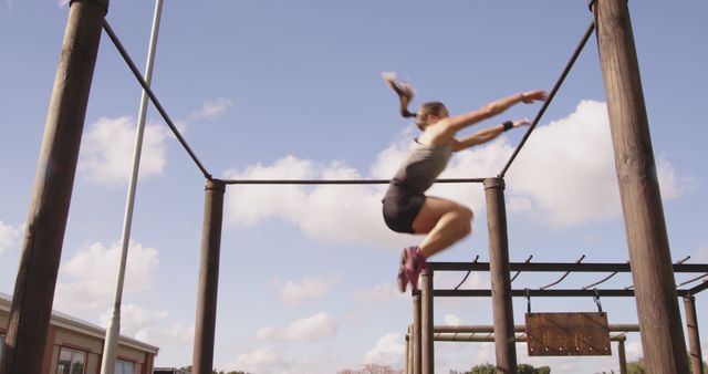 Woman Jumping Off Wooden Platform in Outdoor Obstacle Course - Download Free Stock Images Pikwizard.com