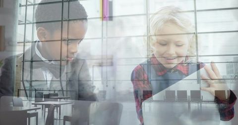 Diverse children waiting and using tablet behind glass reflections in modern lounge