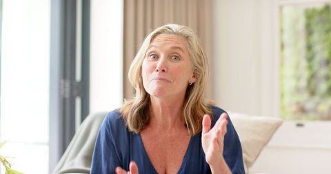Mature woman expressing excitement in casual home setting